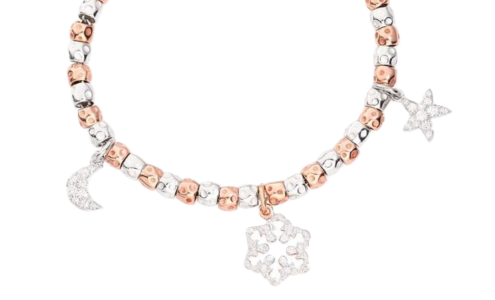 A close-up of a white and rose gold Dodo charm bracelet with a crescent moon, a star, and snowflake charms, available at Chrono Jewelry.