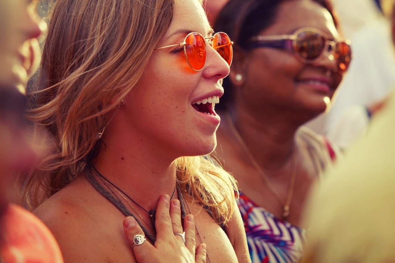 A close-up of two young women dressed and accessorized for a hot summer’s day.