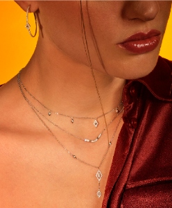 Djula diamond jewelry necklaces and hoop earrings.