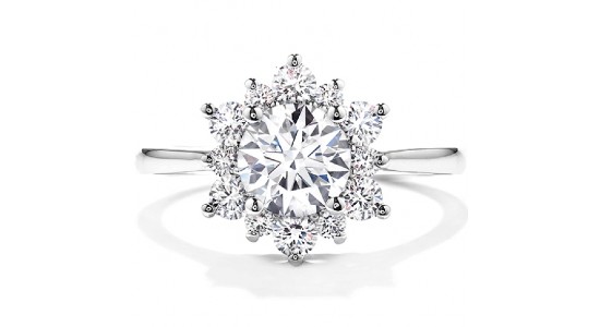 a white gold halo engagement ring with a round cut center stone and a snowflake like silhouette