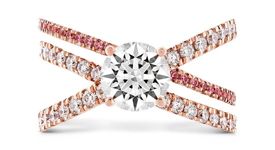 Pink sapphires and diamonds on criss cross rose gold bands holding a stunning round center stone diamond by Hearts On Fire