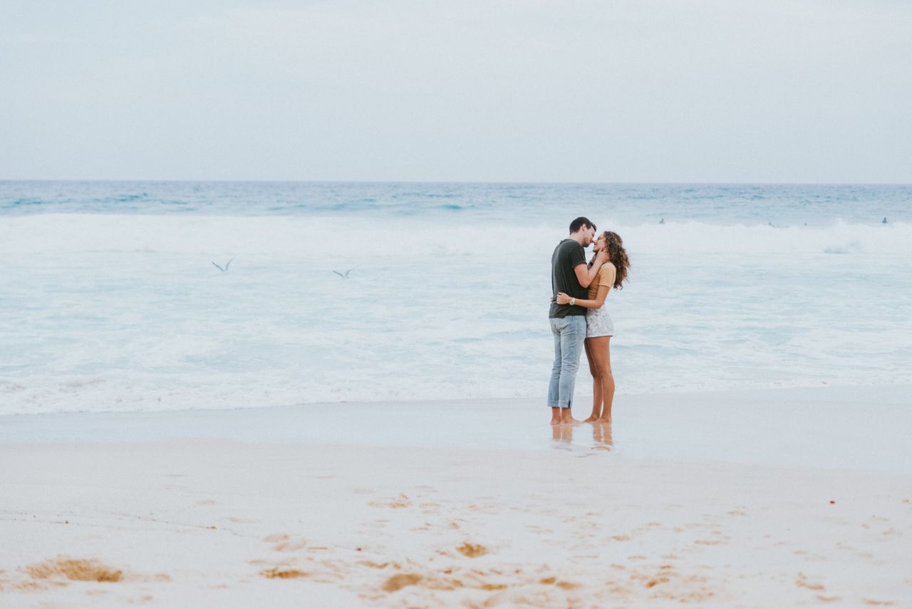 a couple embracing on a beach