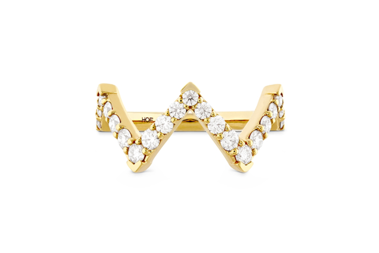 A zigzag yellow gold ring with diamond accents.