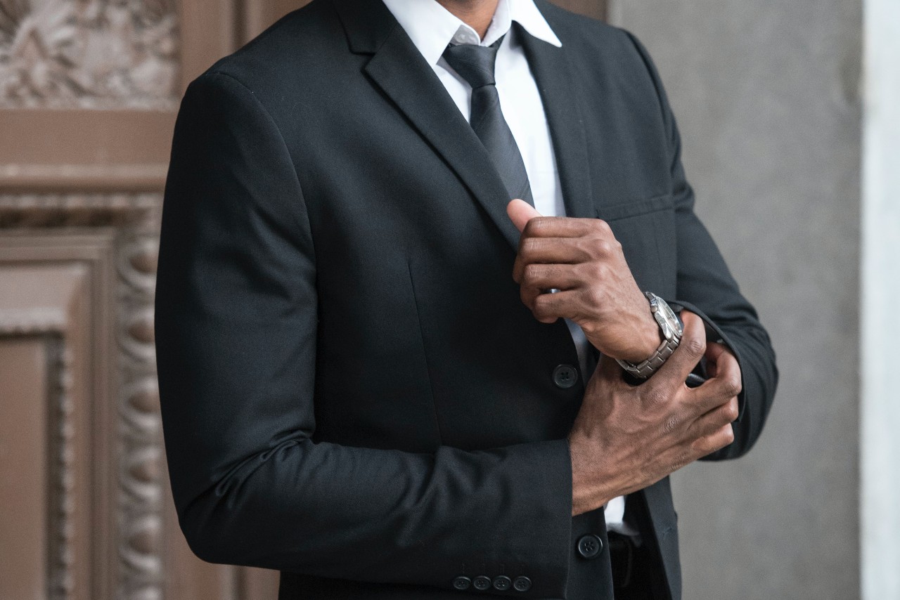 man in a fine suit wearing a luxury watch