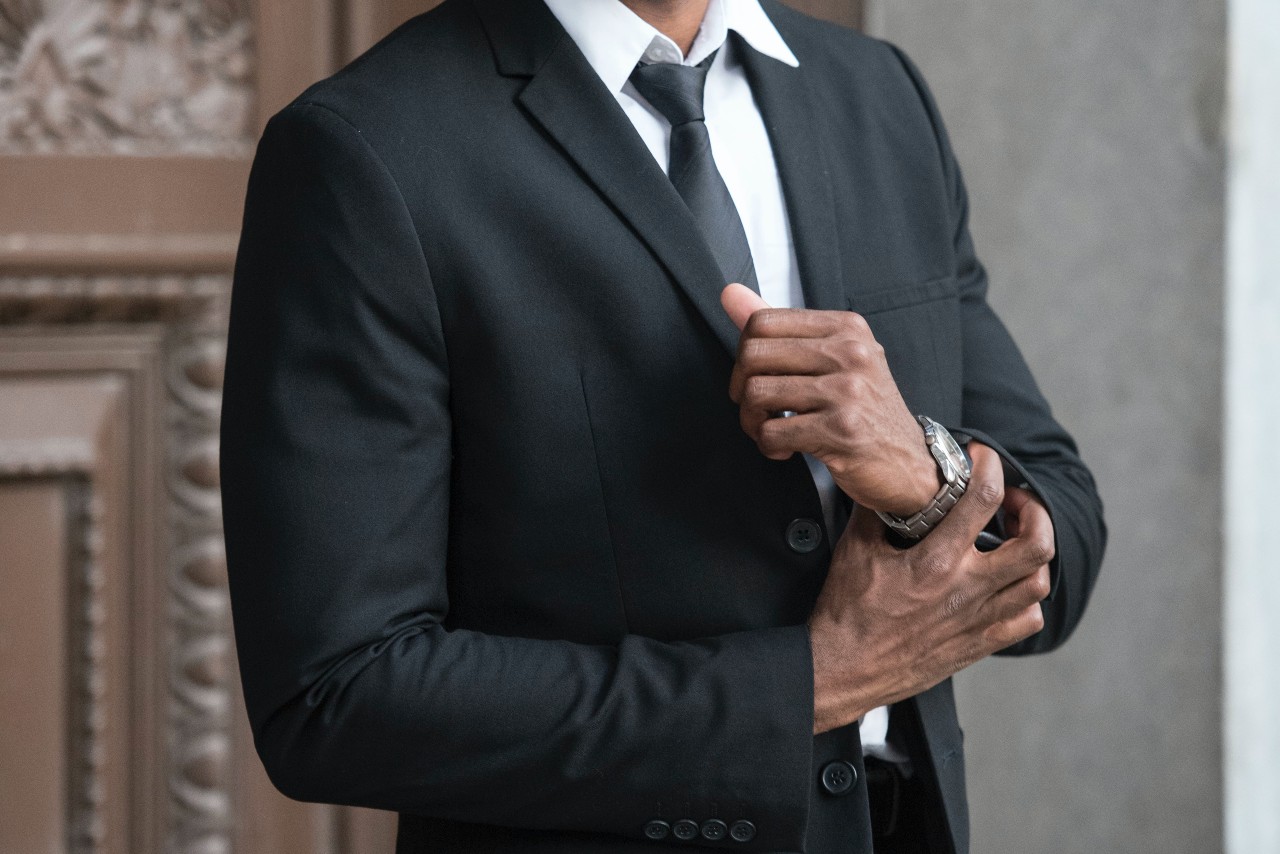 man in a fine suit wearing a luxury watch man in a fine suit wearing a luxury watch