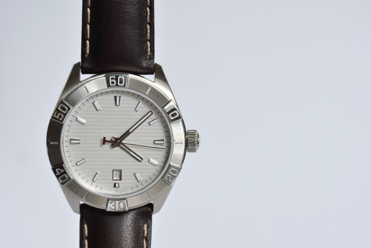 a fine men’s watch with a gray background