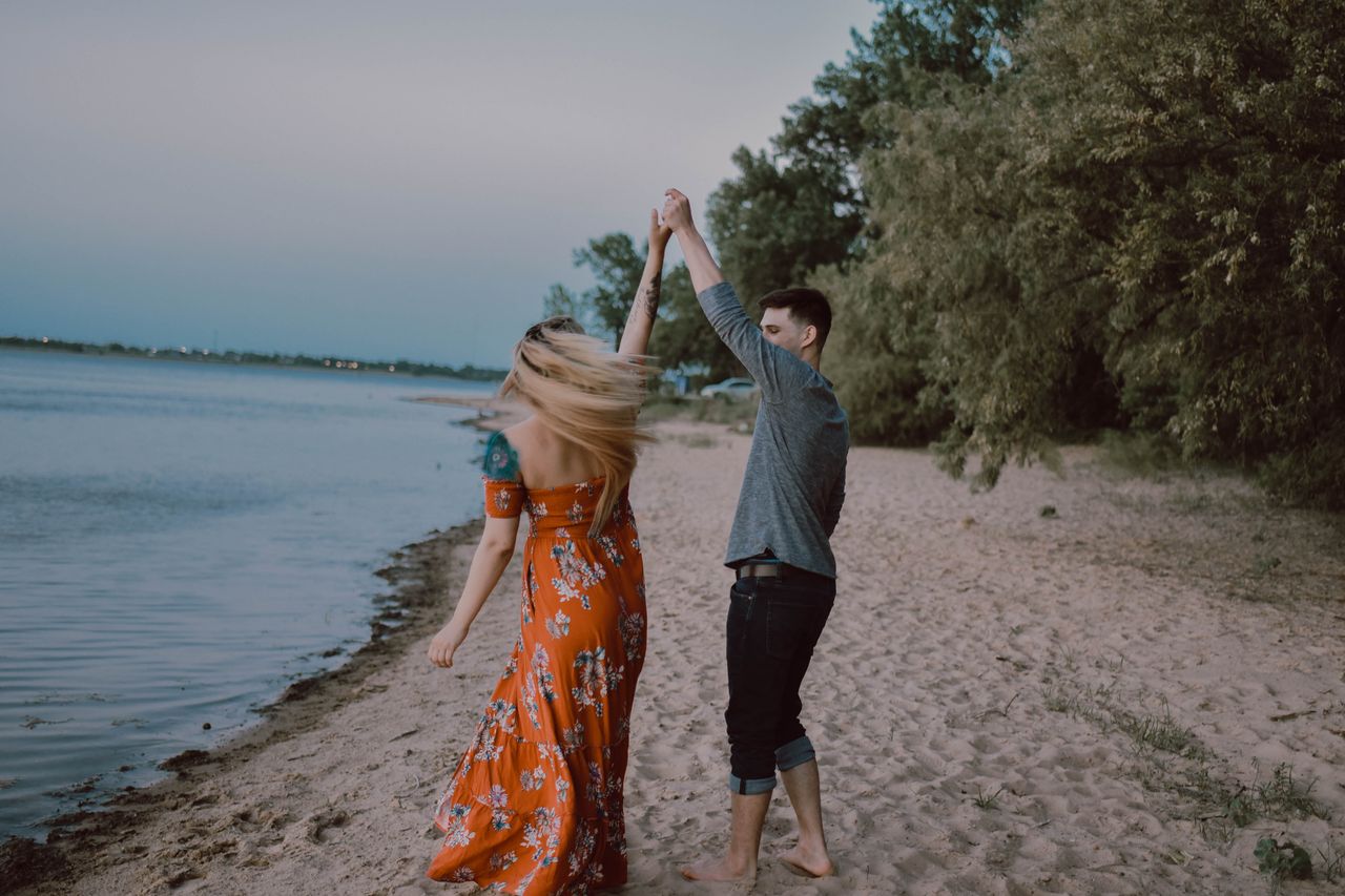 a couple dances on the beach.